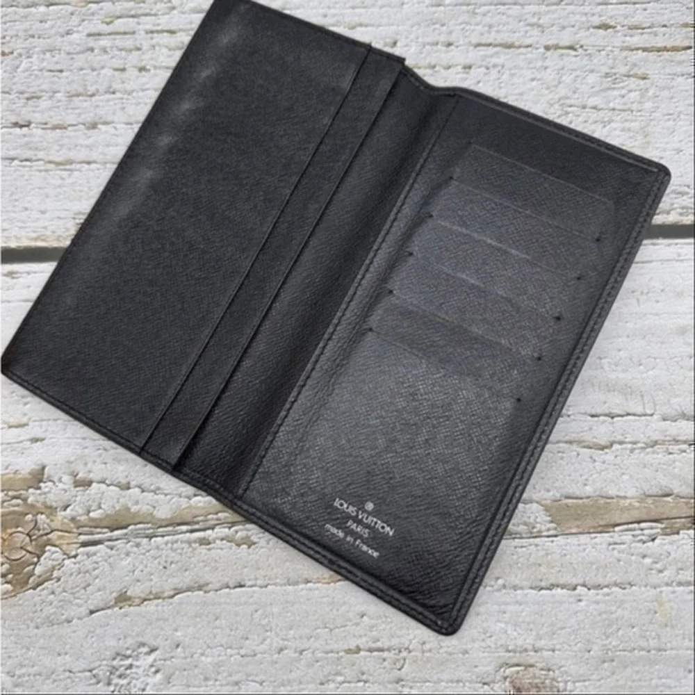 AUTHENTIC Louis Vuitton Taiga wallet. Previously owned. Color: Black.